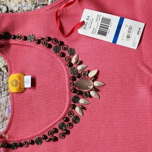 Beautiful coral tank with neck line decor.